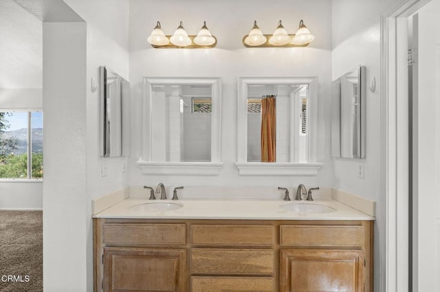 full bathroom featuring double vanity and a sink