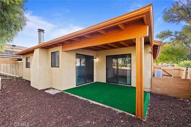 rear view of house featuring central air condition unit