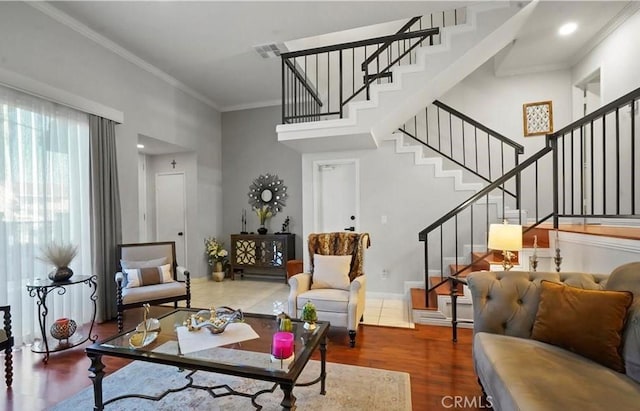 living room with crown molding and hardwood / wood-style flooring