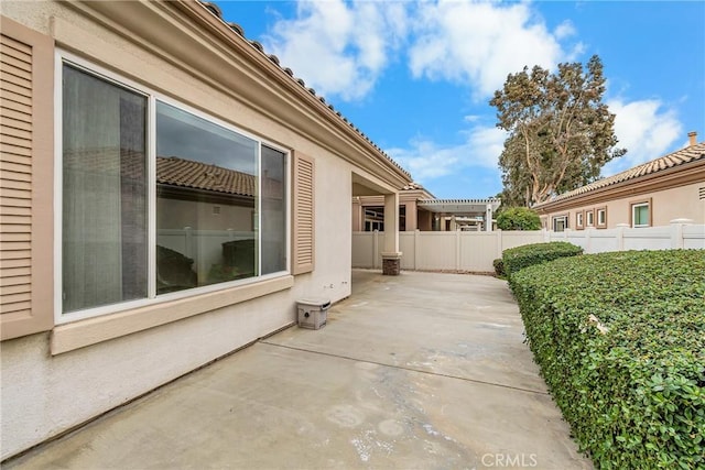 view of side of property with a patio