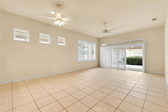 tiled spare room with ceiling fan