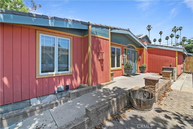 view of side of property featuring central AC and a patio area