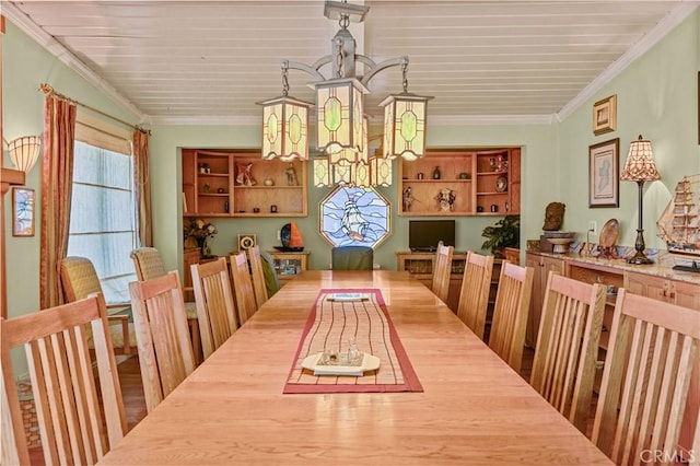 dining area featuring ornamental molding and a chandelier