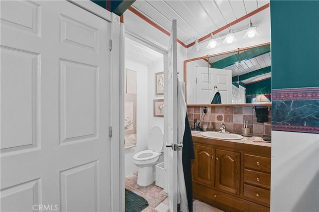 bathroom with tile patterned flooring, backsplash, vanity, wooden ceiling, and toilet