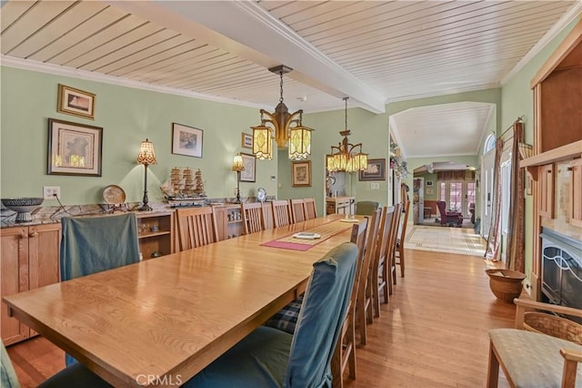 dining space with crown molding, wooden ceiling, a chandelier, and light wood-type flooring