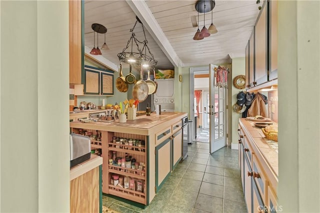 kitchen featuring butcher block counters, hanging light fixtures, wooden ceiling, light tile patterned floors, and beamed ceiling