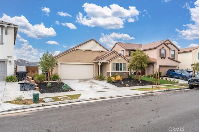 view of front of property featuring a garage and a mountain view