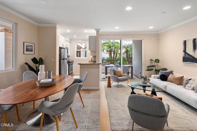 interior space with ornamental molding, sink, and light hardwood / wood-style flooring