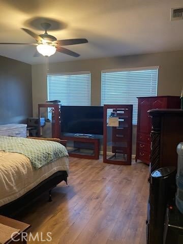 bedroom with ceiling fan and light hardwood / wood-style floors