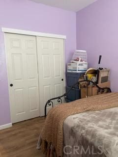 bedroom with hardwood / wood-style floors and a closet