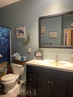 bathroom featuring vanity and toilet