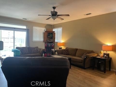 living room featuring ceiling fan and light wood-type flooring