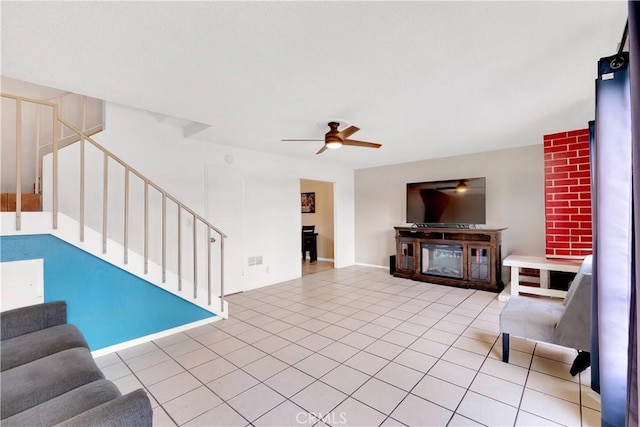 tiled living room with ceiling fan