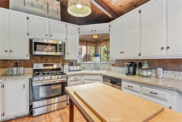 26619 Bel Air Ct, Lake Arrowhead, CA 92352 - kitchen with appliances with stainless steel finishes, a sink, wooden ceiling, white cabinets, and light wood-style floors