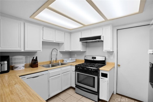 kitchen featuring sink, white cabinetry, stainless steel range with gas stovetop, white dishwasher, and light tile patterned flooring