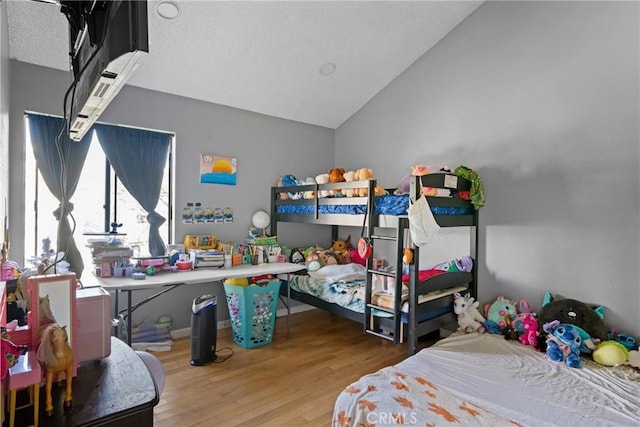 bedroom featuring wood-type flooring and vaulted ceiling