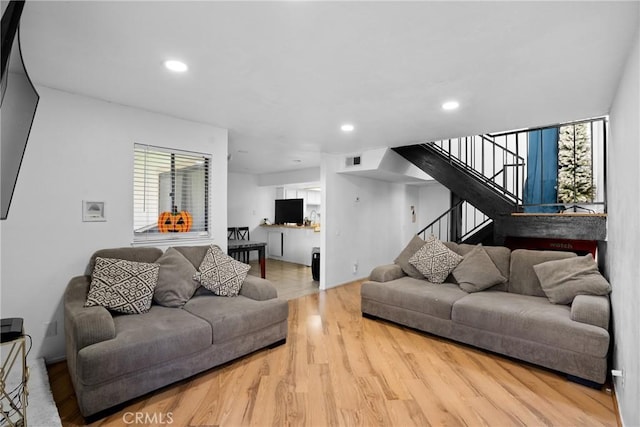 living room featuring a healthy amount of sunlight and light hardwood / wood-style floors