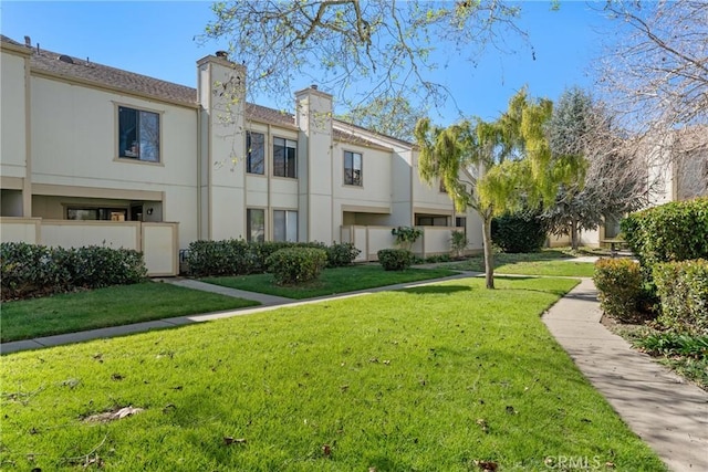 view of home's community featuring a lawn