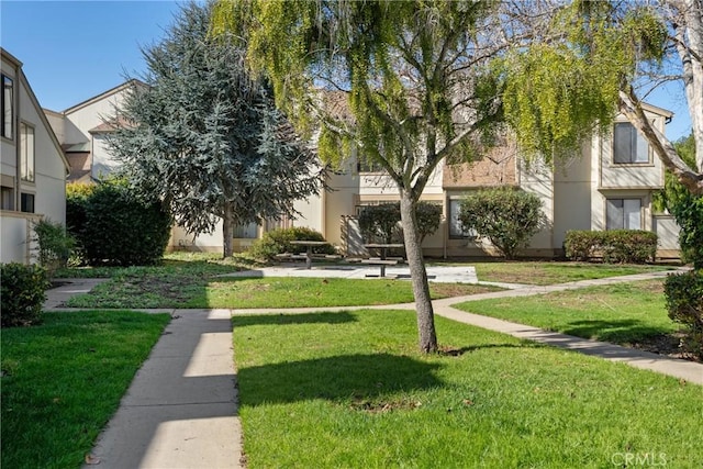 view of property's community with a lawn