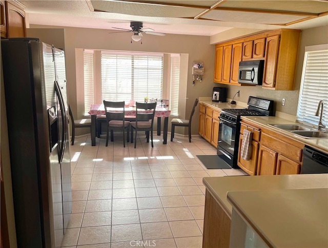 kitchen featuring sink, black appliances, ceiling fan, and light tile patterned flooring