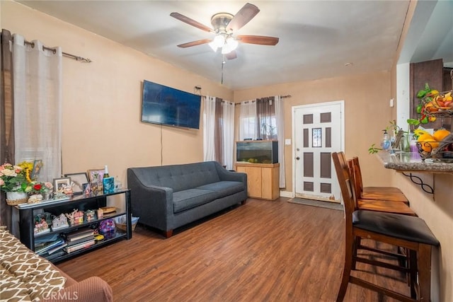 living room featuring wood-type flooring and ceiling fan