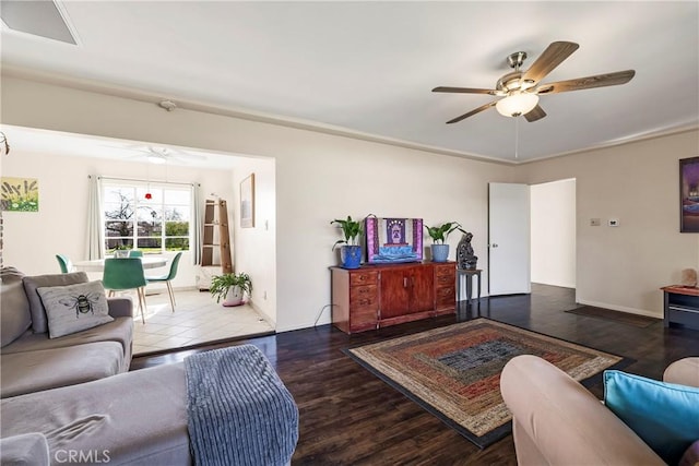 living room featuring dark hardwood / wood-style flooring and ceiling fan