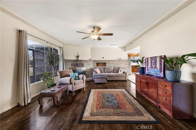 interior space with dark hardwood / wood-style flooring, a fireplace, and ceiling fan