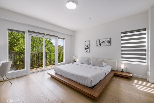 bedroom featuring access to outside and light hardwood / wood-style floors