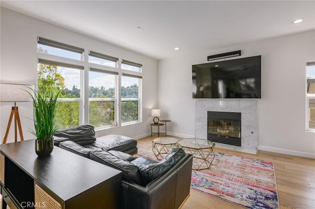 3822 Clayton Ave, Los Angeles, CA 90027 - living room featuring wood finished floors, a high end fireplace, baseboards, and recessed lighting