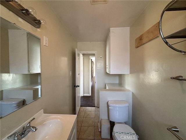 bathroom featuring tile patterned floors, toilet, and vanity