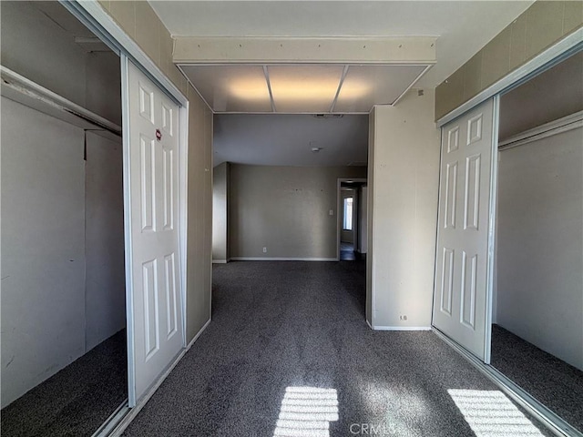 corridor with dark colored carpet