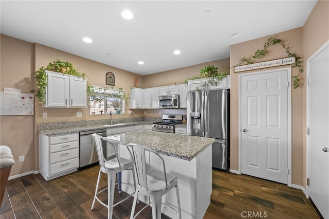 kitchen featuring sink, a center island, white cabinets, and appliances with stainless steel finishes