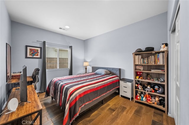 bedroom with dark hardwood / wood-style floors