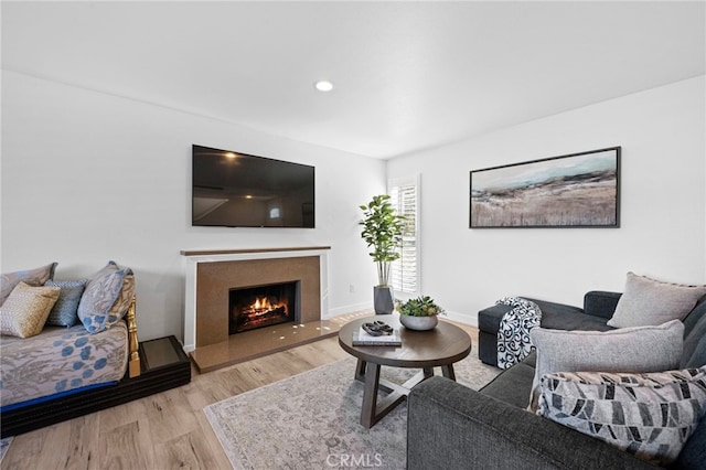 1320 W Fern Ave, Redlands, CA 92373 - living room with recessed lighting, light wood finished floors, a warm lit fireplace, and baseboards