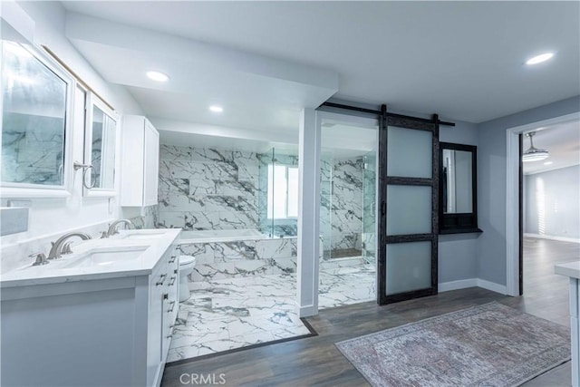 bathroom with vanity, a bathtub, and wood-type flooring