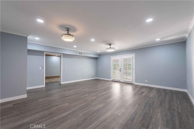 unfurnished room with ornamental molding, dark wood-type flooring, and french doors