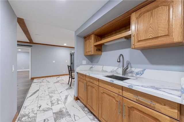 kitchen featuring sink and light stone counters