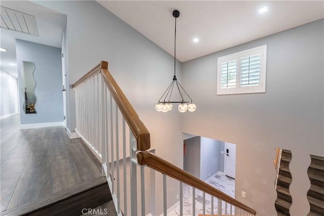 stairs featuring hardwood / wood-style floors