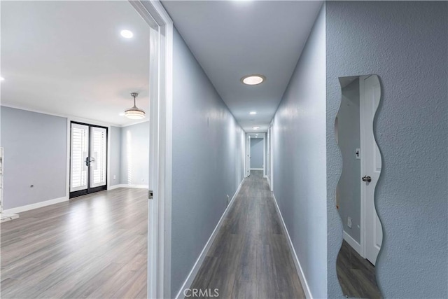 hallway featuring dark wood-type flooring and french doors