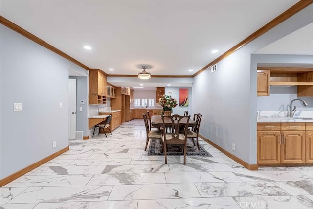 dining area featuring crown molding and sink