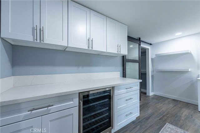 kitchen featuring white cabinetry, a barn door, dark wood-type flooring, and beverage cooler