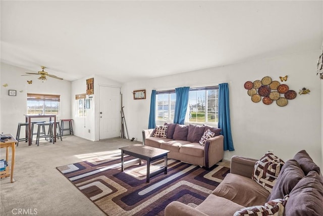 living room featuring a healthy amount of sunlight, ceiling fan, carpet floors, and lofted ceiling