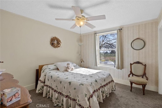 bedroom with a textured ceiling, dark carpet, and baseboards