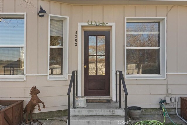 property entrance featuring board and batten siding