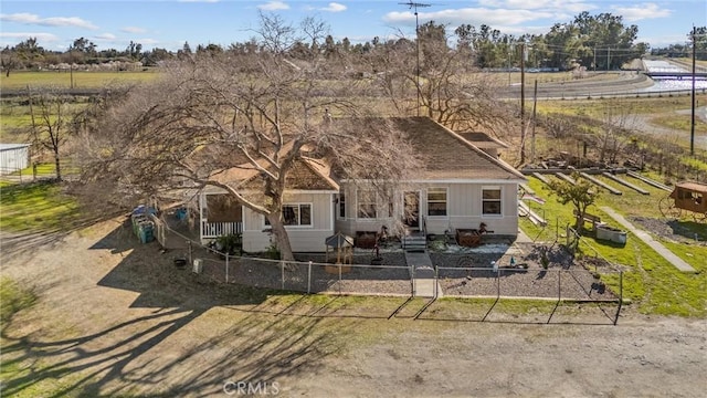 view of front of house with a fenced front yard and central AC