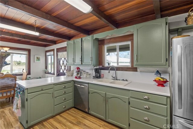 kitchen featuring green cabinets and light countertops