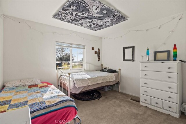 bedroom featuring light colored carpet and visible vents