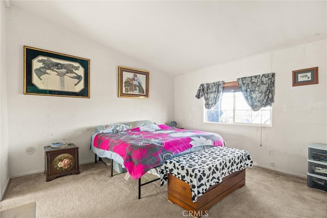 bedroom featuring vaulted ceiling and light colored carpet