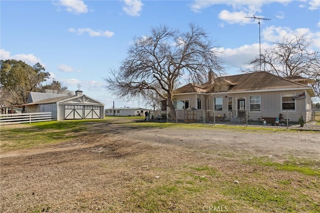 exterior space featuring a fenced front yard and dirt driveway