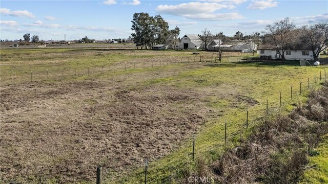 view of yard with a rural view and fence